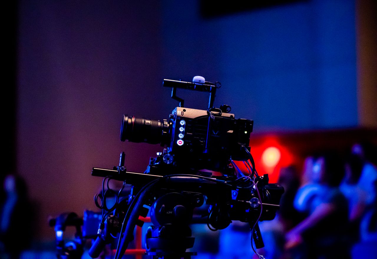 Services A high-quality camera setup capturing a live studio event with an audience in the background.