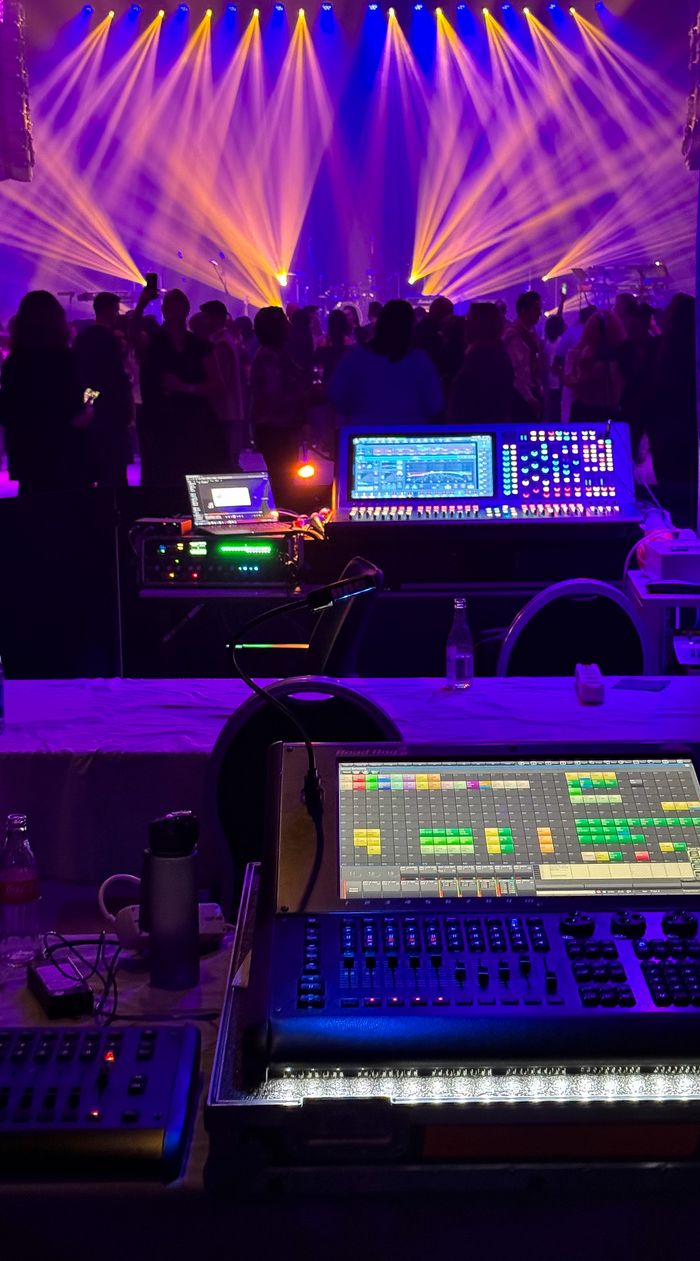 About Dynamic concert scene with colorful stage lights and sound equipment.